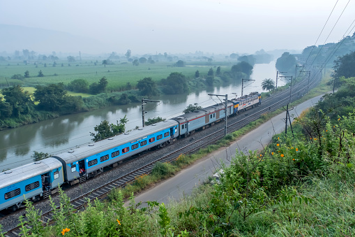 Pune, India - October 15 2023: Passenger train hauled by a WCAM3 electric locomotive near Pune India.