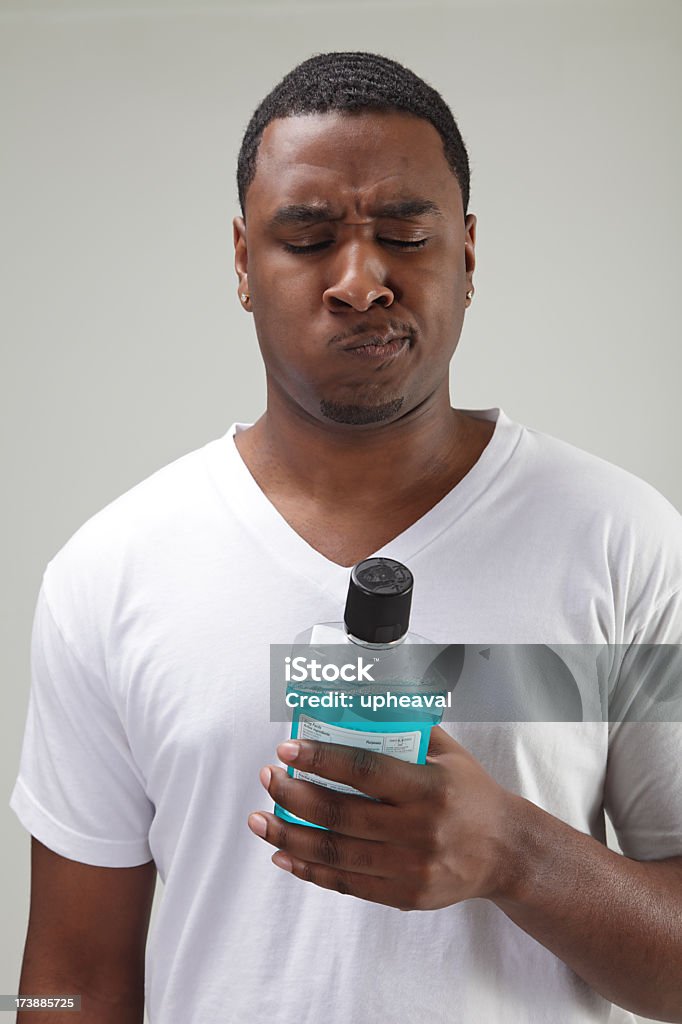 Fluoride Mouthwash African American man using mouthwash. Mouthwash Stock Photo