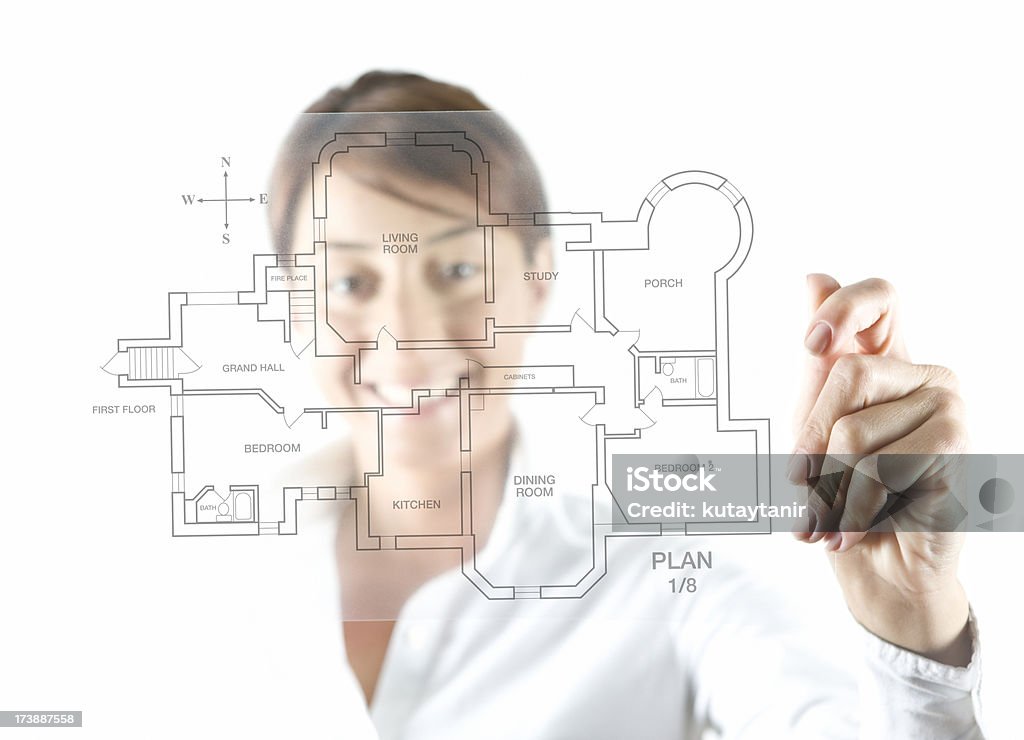 Businesswoman and transparency sheet Businesswoman holding transparency sheet with blueprint on white background. (Focus On Foreground) Adult Stock Photo