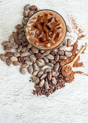 istock Top view of Iced cocoa Drink sweet food menu and brown cocoa powder, Ice chocolate glass, and brown cocoa bean on a white background. 1738877106
