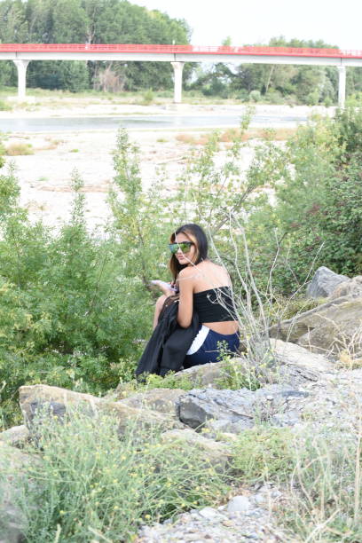 Long haired girl sitting in a sunset