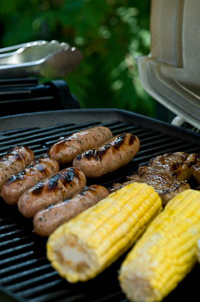 Sausages, Corn Cobs and steaks on BBQ stock photo