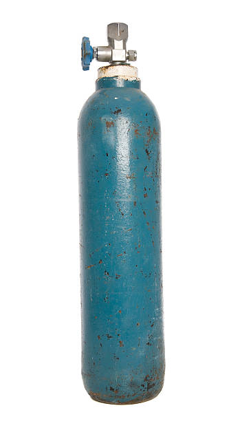 Gas cylinder tank with rust spots and peeling blue paint An Argon bottle isolated on white. argon stock pictures, royalty-free photos & images