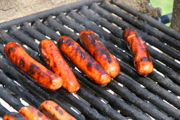 istock Hot Dogs cooking on an Open Grill 173888845