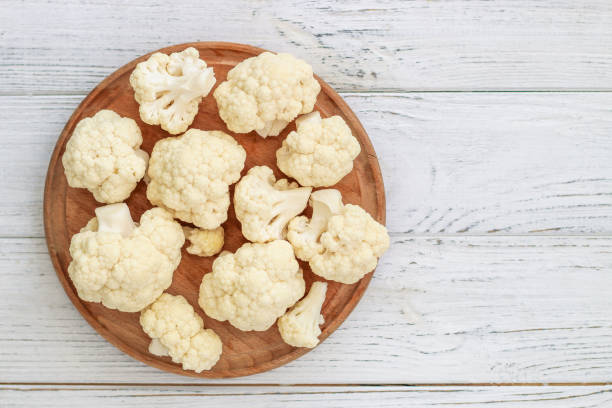 istock Cauliflower vegetables standing on a white wooden table 1738889214