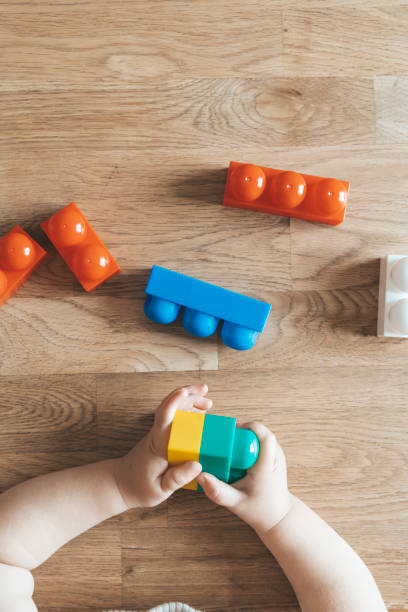 istock Child development. Montessori toy blocks and a child, a baby playing. Early development, kindergarten, childhood concept. 1738896759