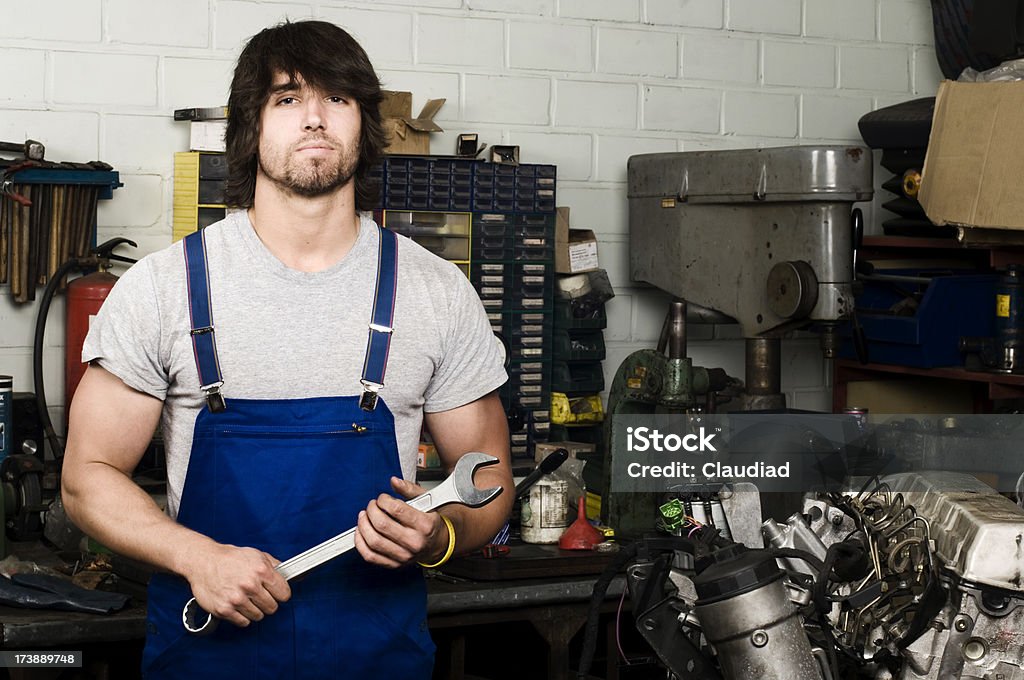 Car mechanic Young man working holding a wrench.More from this model: 20-24 Years Stock Photo
