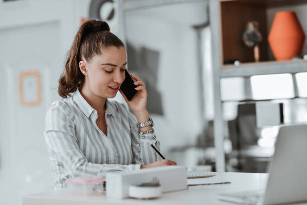 istock Female Accountant Taking Contact Information Over Phone And Writing It Down 1738898619