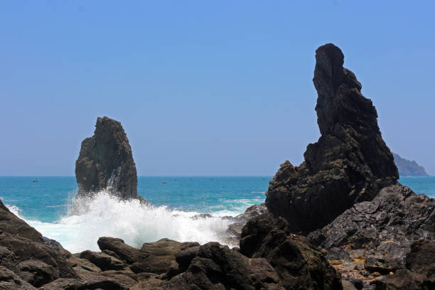 istock Powerful waves crashing rocks in the seashore. 1738906395