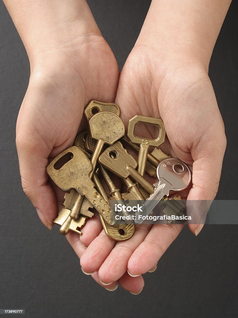 Holding keys Top view of young woman hands holding keys. Shallow depth of field Adult Stock Photo