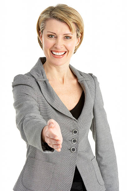 Businesswoman Reaching To Shake Hands stock photo