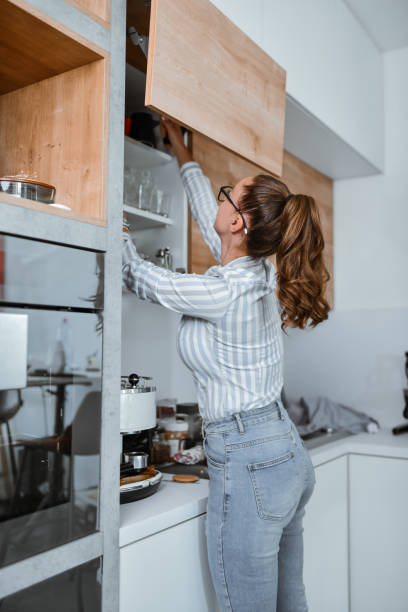 istock Female Storing Clean Dishes After Washing 1738916078