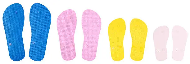 soles of four pairs of flip-flop beach sandals with clipping path.  Can be used to create paths of footprints, feet of people standing in a group, etc.