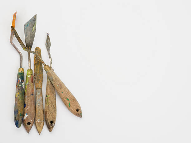 istock Well used palette knives on white surface with copy space 173892559