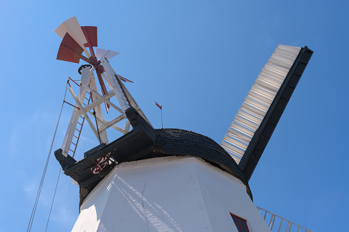 a beautiful anchient white windmill in aarsdale, Bornholm on a sunny day with blue sky