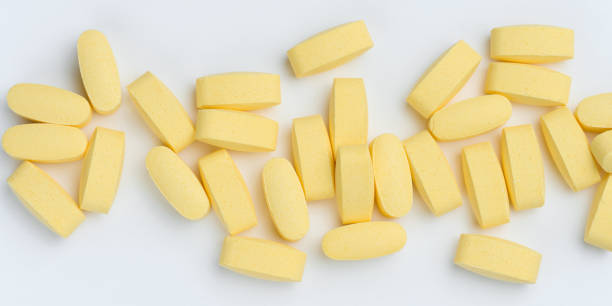 istock Yellow oval tablets on a white background, top view 1738927396
