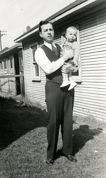 Father holding his infant son in 1937