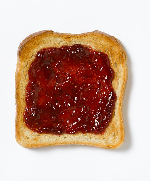 istock Red jam spread evenly onto a piece of toast 173893165