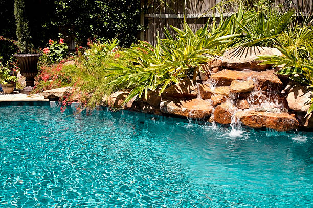 istock Tropical swimming pool with rock waterfall. 173893985