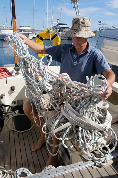 istock Man on a boat with tangled ropes 173894112