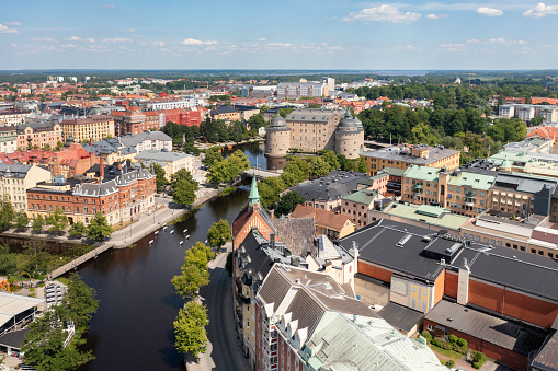 Aerial view of central Örebro city in summer, with Svartån river and Örebro Slott (castle) in the background.