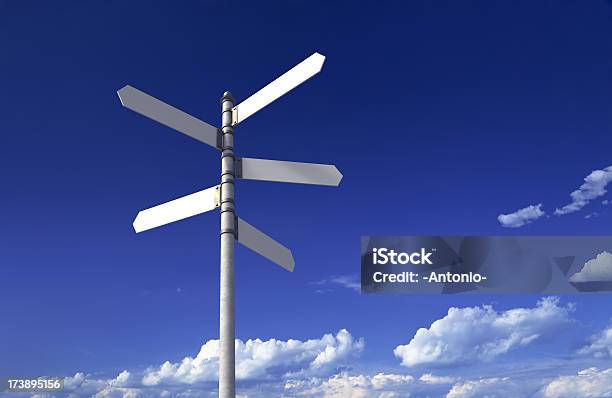 Signpost With Three Blank Signs On Sky Backgrounds Stock Photo - Download Image Now - Directional Sign, Road Sign, Crossroads Sign