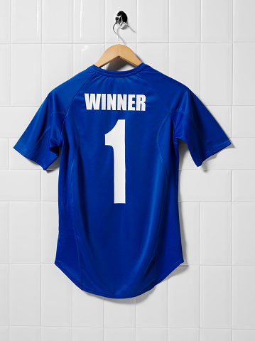 Blue football shirt hanging in a tiled changing room.Click on the link below to see more of my sport images