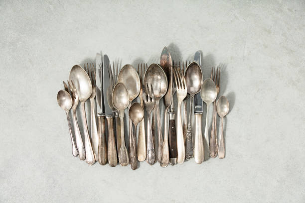 Rustic vintage cutlery on grey stone background flat lay stock photo