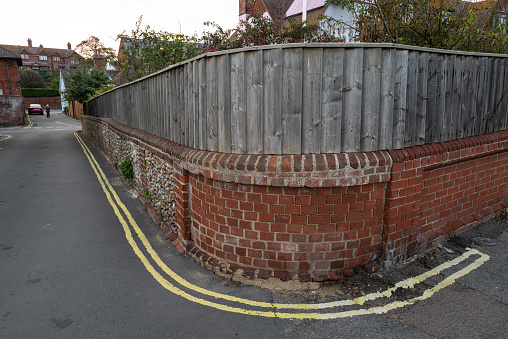 Unusual curved wall with an equally unusual set of double yellow lines. The area is close to a beach front setting in the UK.