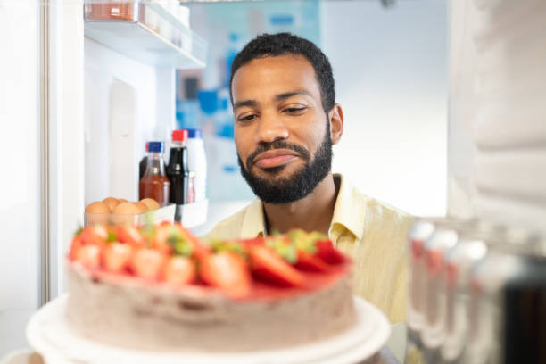 istock Delighted young black man looking at food in his refrigerator 1738955988