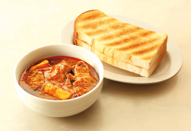Asian food chicken curry served with toasted bread
