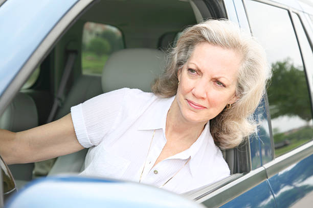 istock Senior Woman Looking Ahead while in her car 173895718