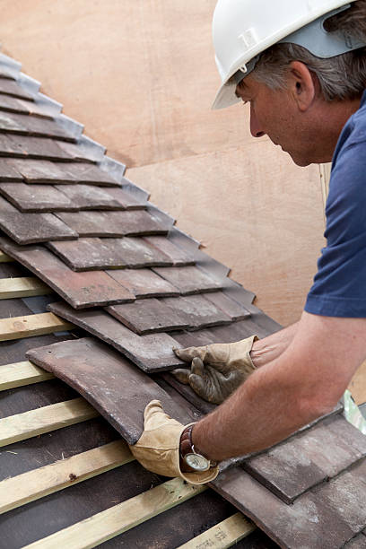 istock Construction Site Roofer Laying Roof Tiles 173896031