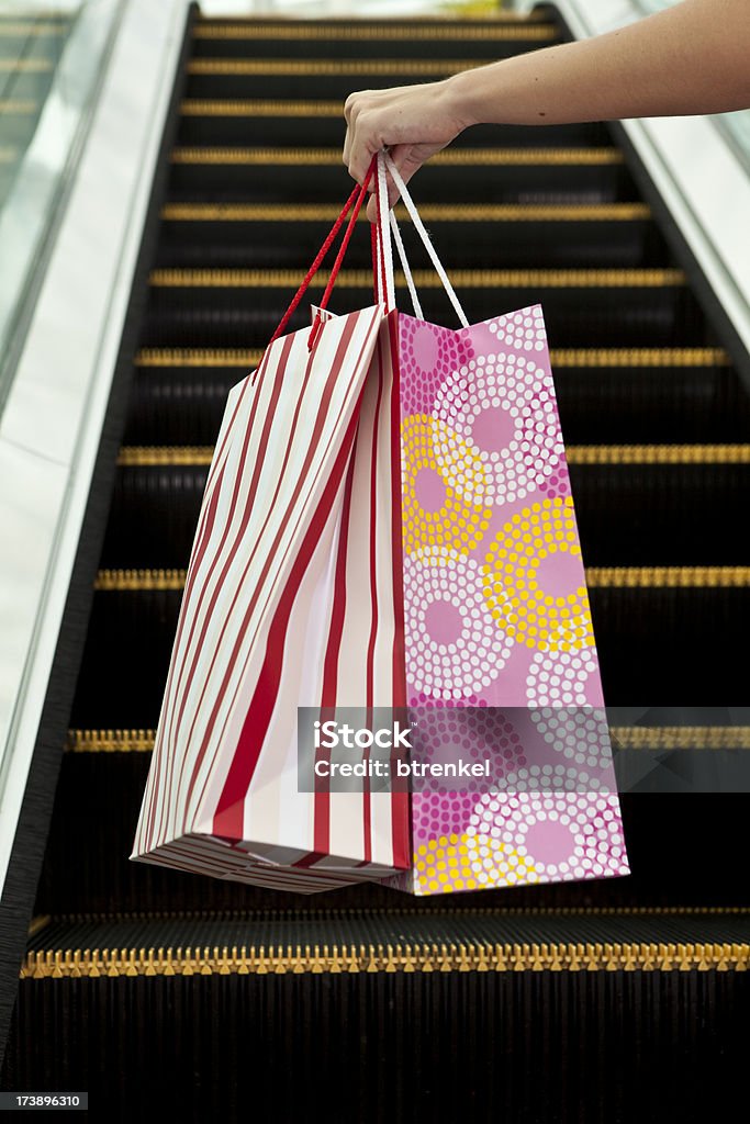 Shopping Close up - shopper with shopping bags on escalator Close-up Stock Photo