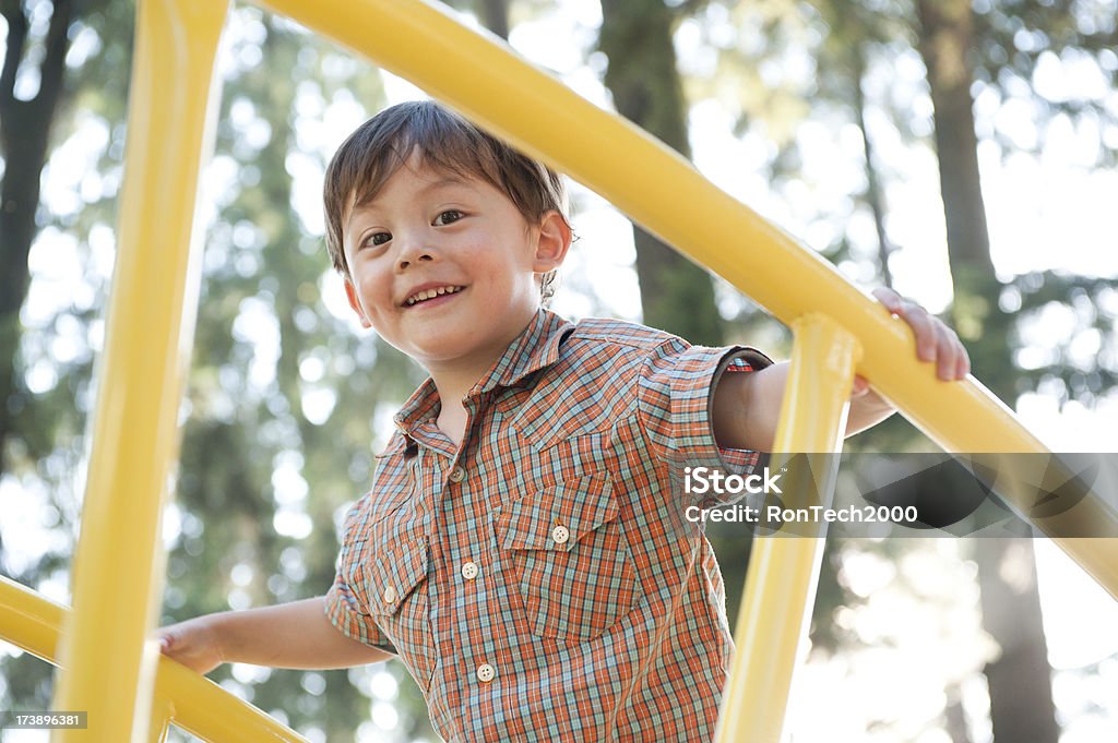 Boy at Playground youngster at playground / climbing on the monkey bars / having a good time Close-up Stock Photo