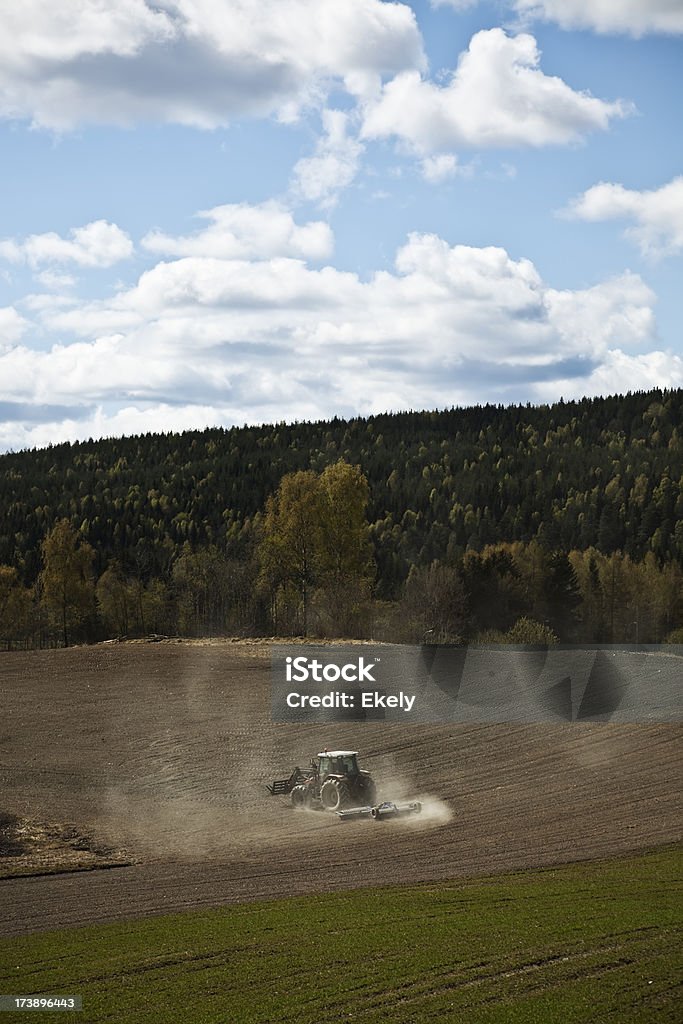 Farmer on his tractor plowing the field. Farmer on his tractor plowing the field. Norway. Agricultural Field Stock Photo