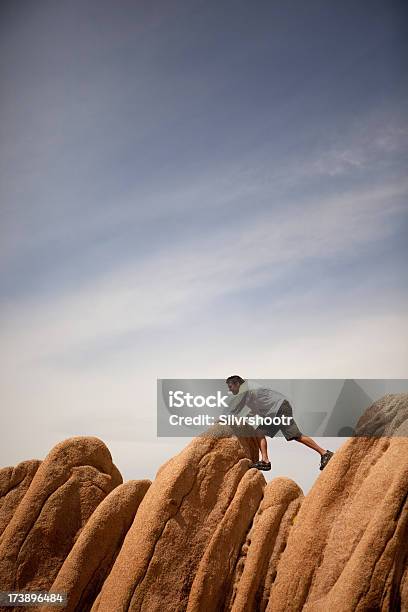 Uomo Cercando Di Ottenere Su Boulders Nel Deserto - Fotografie stock e altre immagini di Affari - Affari, Avversità, California