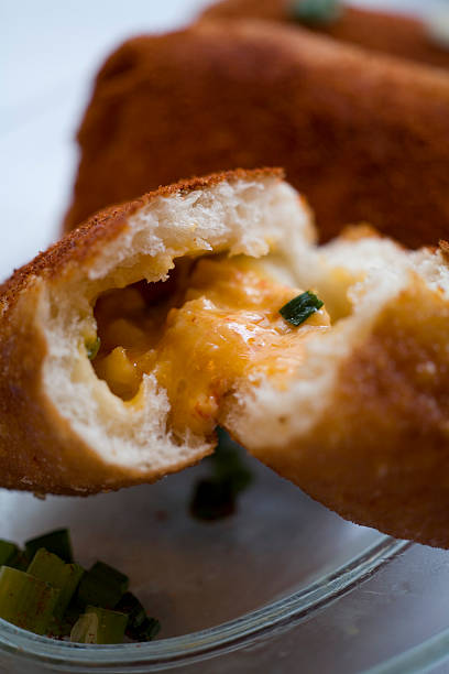 fritters Savory deep fried pockets filled with crawfish, cheddar cheese and green onion.  Originally shot for a San Francisco Magazine restaurant review. beignet stock pictures, royalty-free photos & images