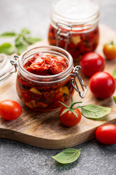 istock Jars with sun dried tomatoes with fresh herbs and spices. 1738970953