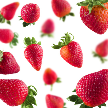 Strawberries free fall on White Background 