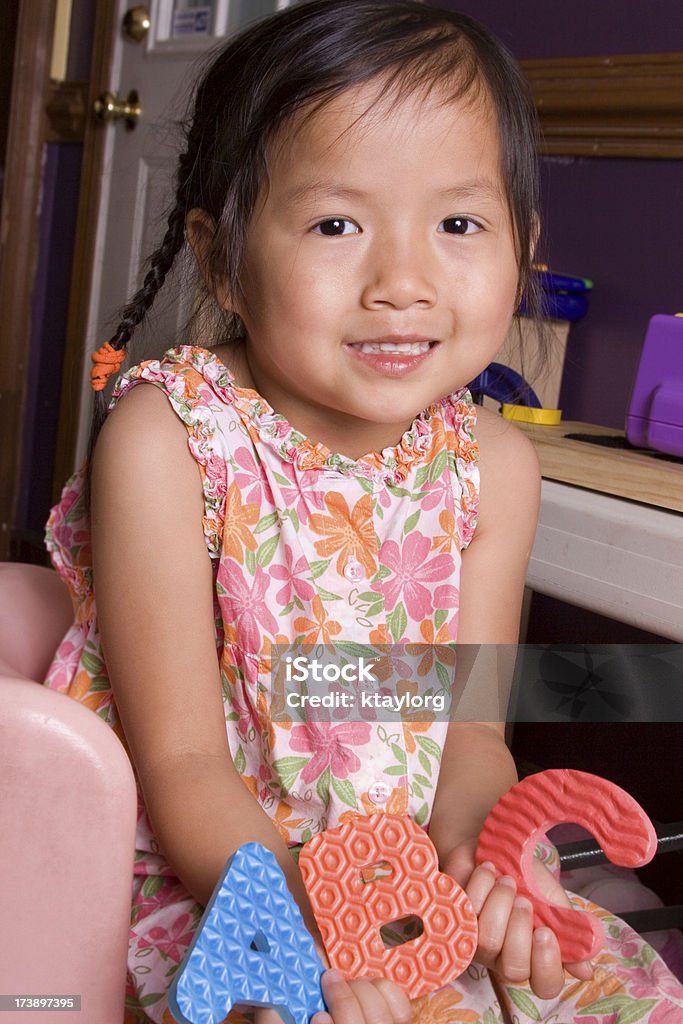 Girl holding Letters A, B, and C Chinese little girl holds her ABC's (shallow dof) 2-3 Years Stock Photo