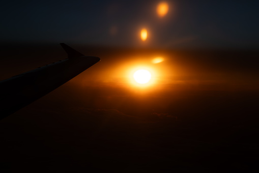 Sunrise at high altitude from the window of an aircraft taken when flying over Europe in January