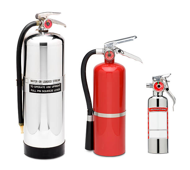 Three Fire Extinguishers stock photo