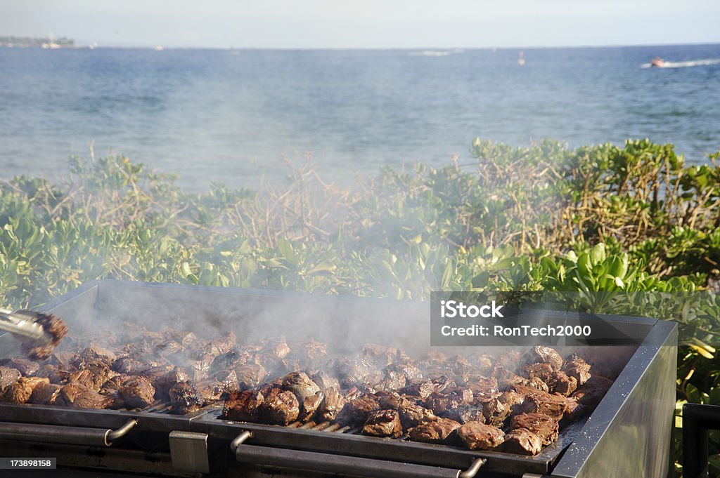 Luau BBQ meat for a luau / cooking it up on the grill / beside the ocean Barbecue - Meal Stock Photo