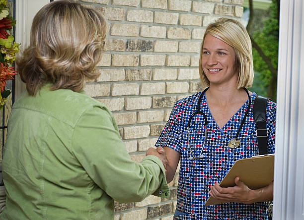 istock Nurse at front door of residence 173898202