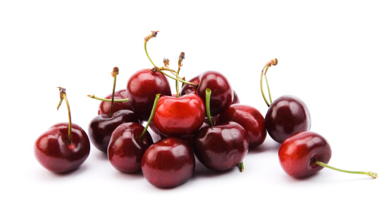 Lots of ripe red cherries. Isolated on white background. File contains clipping path