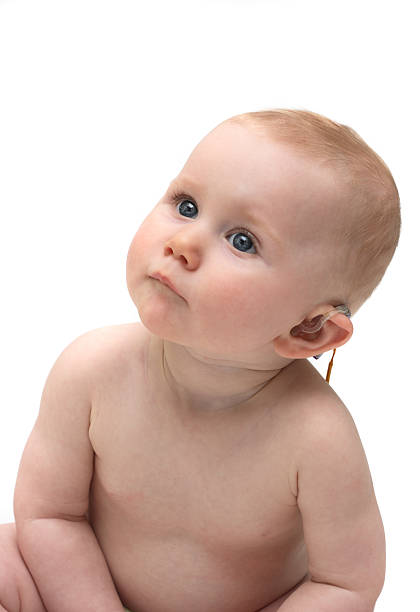 Cute baby girl with hearing aid stock photo