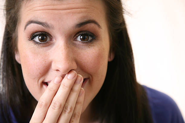 istock Young Woman With Her Hand to Mouth 173899504