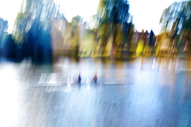 Rowboat with two rowers on a river. . Bright sunlight. Vibrant color. Blurred motion.