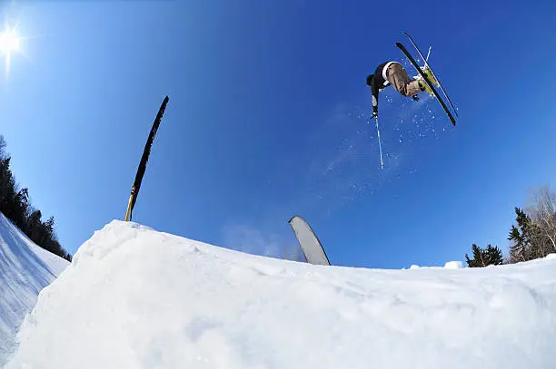 Photo of Skier  launching over a jump in terrain park